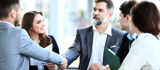 Business professionals shaking hands in a modern office