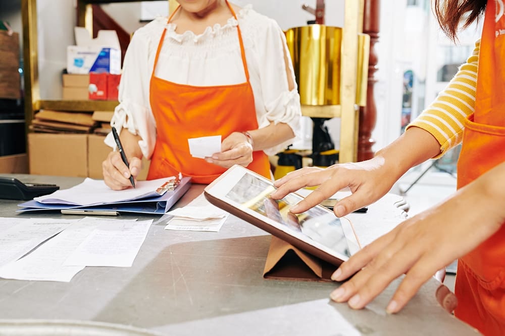 Employees using self-service tools at a retail counter